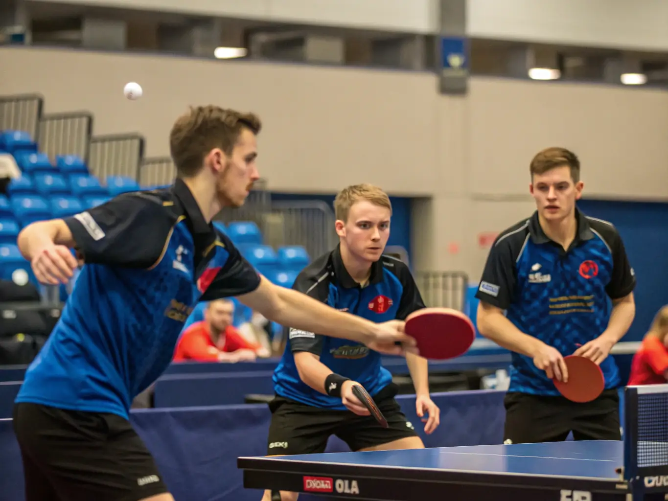 A dynamic image of adult players engaged in a competitive table tennis match, showcasing intense rallies and strategic gameplay, set in a professional tournament environment.