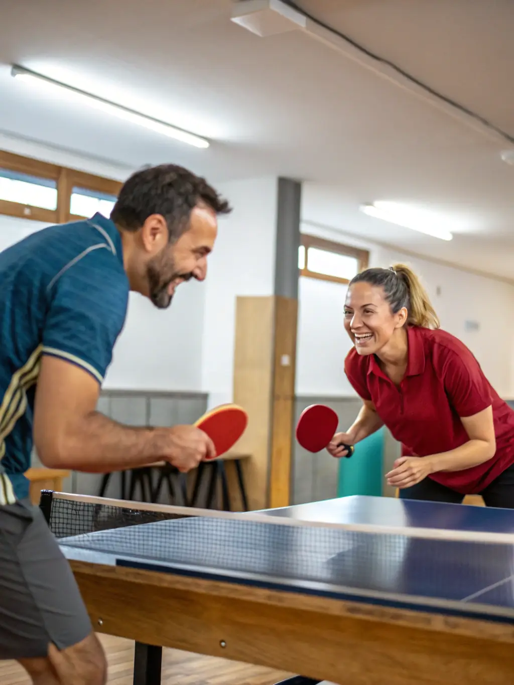 A group of adult players engaged in a friendly yet competitive table tennis match at the club, showcasing the social and recreational aspects of the sport.